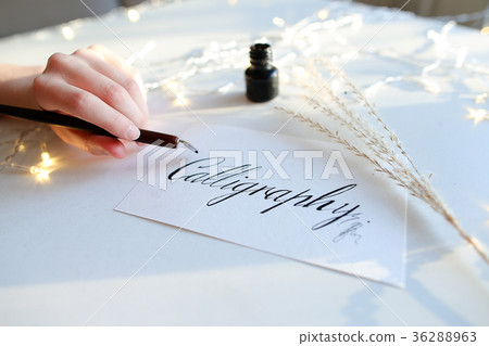 Female master of lettering of ink writes word on 36288963