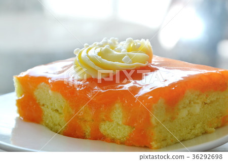 orange butter cake jam topping cream on dish 36292698