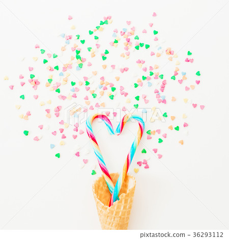 Bright candy canes with confetti and waffle cone Bright candy canes with confetti and waffle cone 36293112