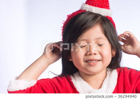 A Little Cute Asian girl in Santa Cross dress on Isolate white b A Little Cute Asian girl in Santa Cross dress on Isolate white b 36294940
