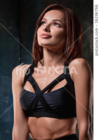 Muscular young woman athlete on black 36296766