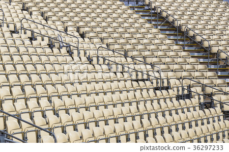 Rows of plastic chairs for spectators in the stand 36297233