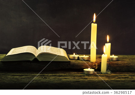 Bible and candle on a old oak wooden table Bible and candle on a old oak wooden table 36298517