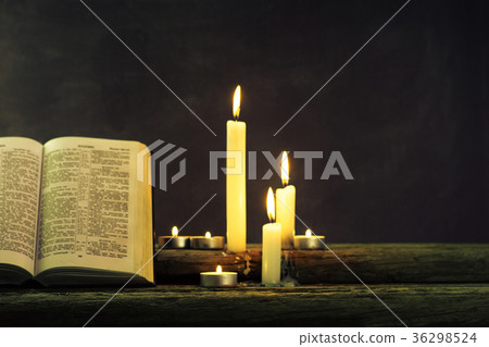 Bible and candle on a old oak wooden table Bible and candle on a old oak wooden table 36298524
