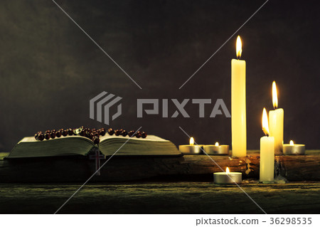 Bible and candle on a old oak wooden table Bible and candle on a old oak wooden table 36298535