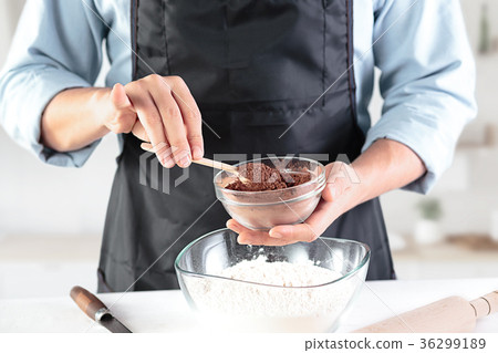 A cook with eggs on a rustic kitchen against the 36299189