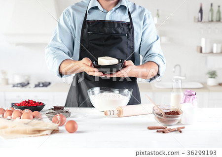 A cook with eggs on a rustic kitchen against the 36299193