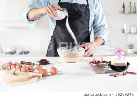A cook with eggs on a rustic kitchen against the A cook with eggs on a rustic kitchen against the 36299248