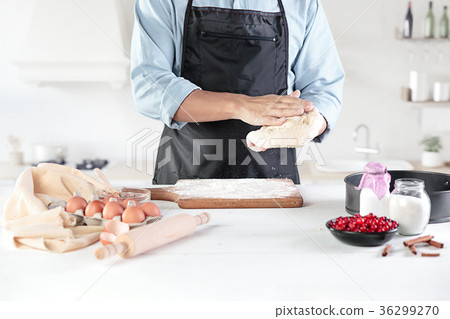 A cook with eggs on a rustic kitchen against the 36299270