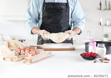 A cook with eggs on a rustic kitchen against the 36299271