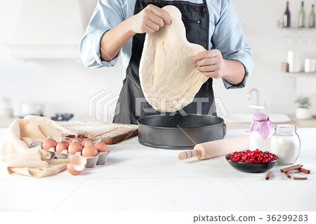 A cook with eggs on a rustic kitchen against the A cook with eggs on a rustic kitchen against the 36299283