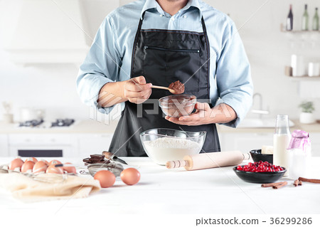 A cook with eggs on a rustic kitchen against the 36299286