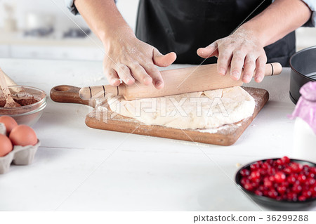A cook with eggs on a rustic kitchen against the 36299288