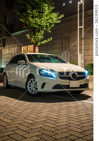 Cityscape at night with white car 36299615