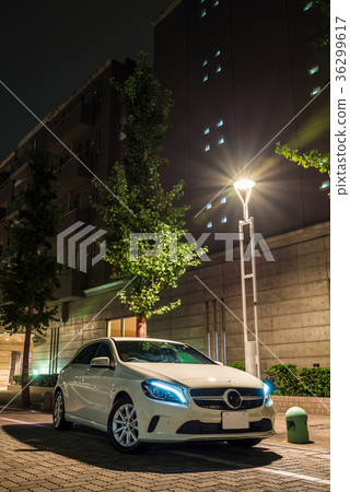 Cityscape at night with white car 36299617