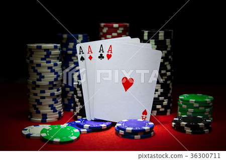 Four aces with a lot of chips on the poker table. Four aces with a lot of chips on the poker table. 36300711