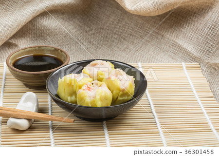shrimp shumai in a ceramic dish on bamboo mat 36301458