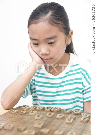 Elementary school girl pointing at shogi 36301729