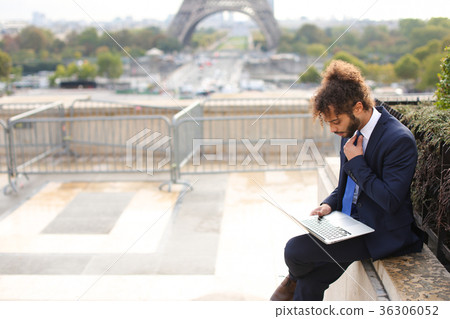 Mixed blood businessman working with laptop near 36306052