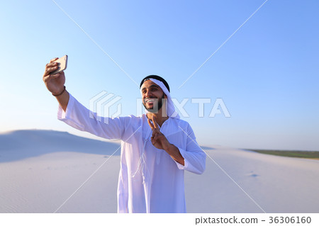 Portrait of Arabian sheikh man with gadget that Portrait of Arabian sheikh man with gadget that 36306160