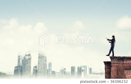 Danger and risk concept with businessman making step from edge 36306232