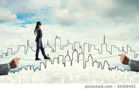 Business concept of risk support and assistance with man balancing on rope 36306482