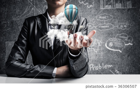 Woman presenting flying balloon in hand. Woman presenting flying balloon in hand. 36306507
