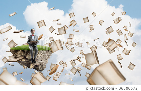Young businessman or student studying the science and books fly around Young businessman or student studying the science and books fly around 36306572