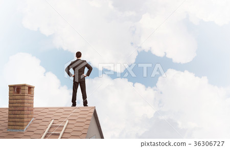 Mister boss on brick roof with arms akimbo. Mixed media Mister boss on brick roof with arms akimbo. Mixed media 36306727