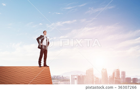 Mister boss on brick roof with arms akimbo. Mixed media Mister boss on brick roof with arms akimbo. Mixed media 36307266