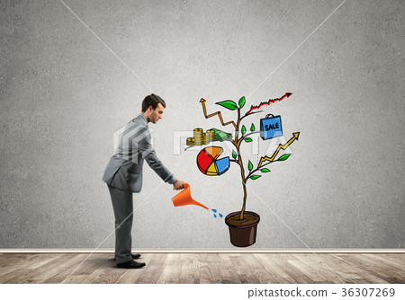 Young businessman in empty room watering drawn growth concept with can 36307269