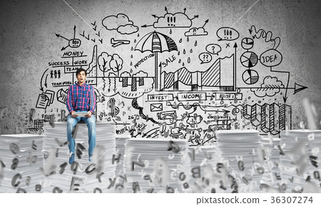 Attractive man sitting on pile of paper documents. 36307274