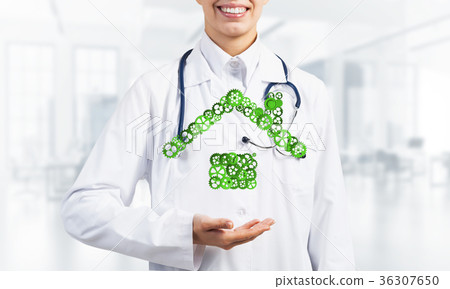 Symbol of homepage or accomodation made with cogwheels presented in female palms Symbol of homepage or accomodation made with cogwheels presented in female palms 36307650