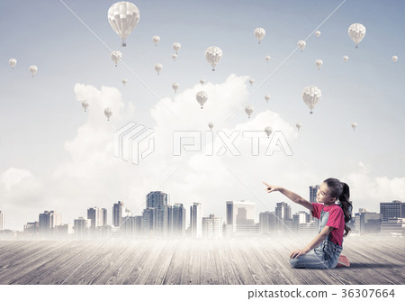 Concept of careless happy childhood with girl pointing at someth 36307664