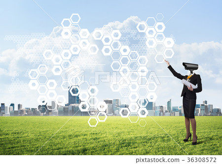Camera headed woman standing on green grass against modern cityscape Camera headed woman standing on green grass against modern cityscape 36308572
