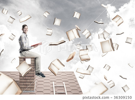 Man reading book and many of them flying in air 36309150