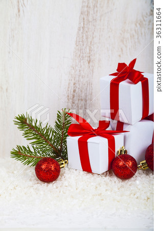 Gifts with red bows on snow Gifts with red bows on snow 36311664