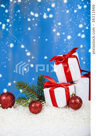 Gifts with red bows on snow Gifts with red bows on snow 36311666