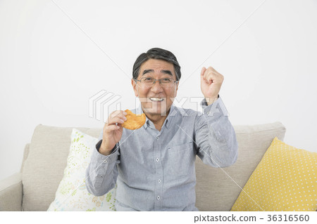 Tooth health Senior man posing for guts holding rice cracker 36316560