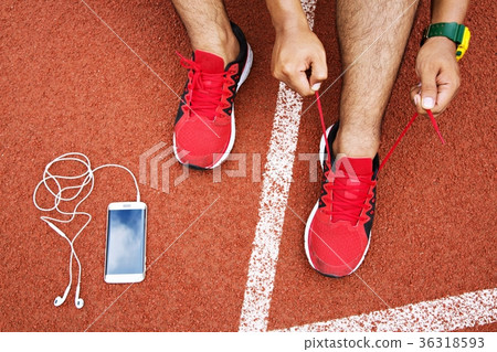 Runner young man tying shoelace  36318593