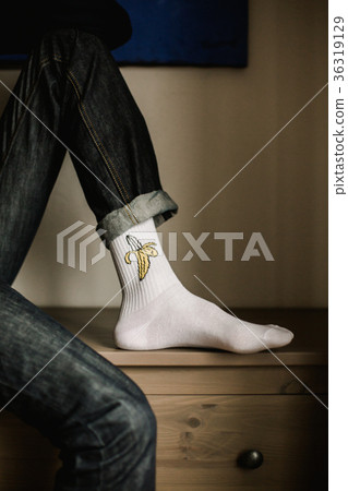 Feet in woollen socks. Man is relaxing with a cup 36319129