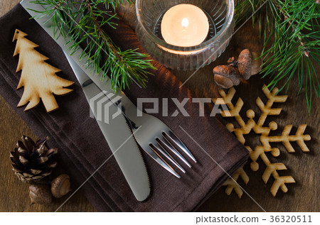 Rustic Christmas table setting with candle. Rustic Christmas table setting with candle. 36320511