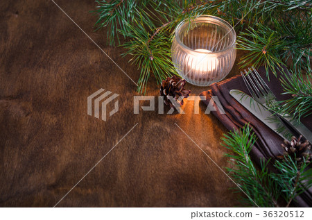 Rustic Christmas table setting with candle. Rustic Christmas table setting with candle. 36320512