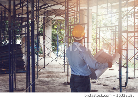 Engineer with blueprint in construction site 36322183