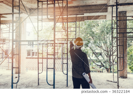 Engineer with blueprint in construction site Engineer with blueprint in construction site 36322184