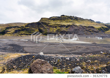 melting ice in bed of Solheimajokull glacier 36324778