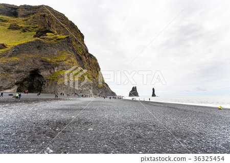 tourists near Halsanefshellir cave on beach 36325454