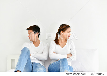 A couple lover is upset about something in the bedroom. 36329057