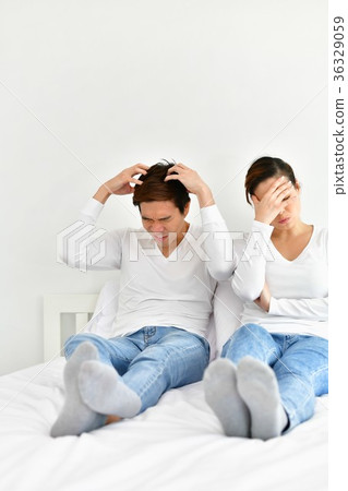 A couple lover is upset about something in the bedroom. 36329059