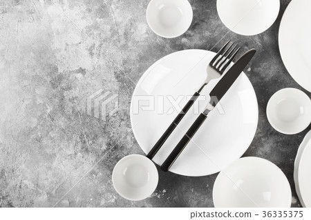 Clean white tableware on a gray background Clean white tableware on a gray background 36335375